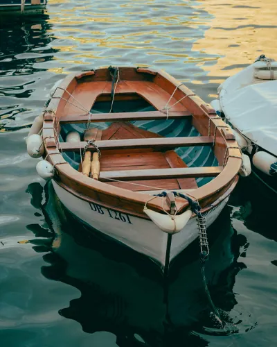 Wooden rowing boat moored in the water